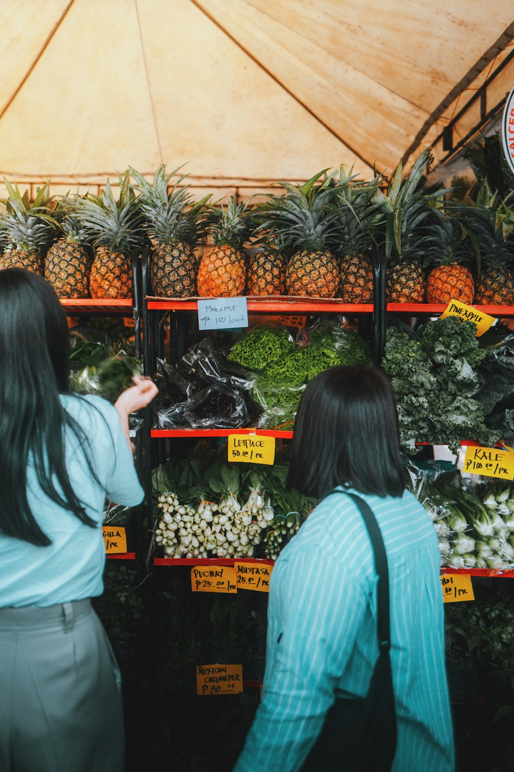 a couple of women standing next to each other in a store