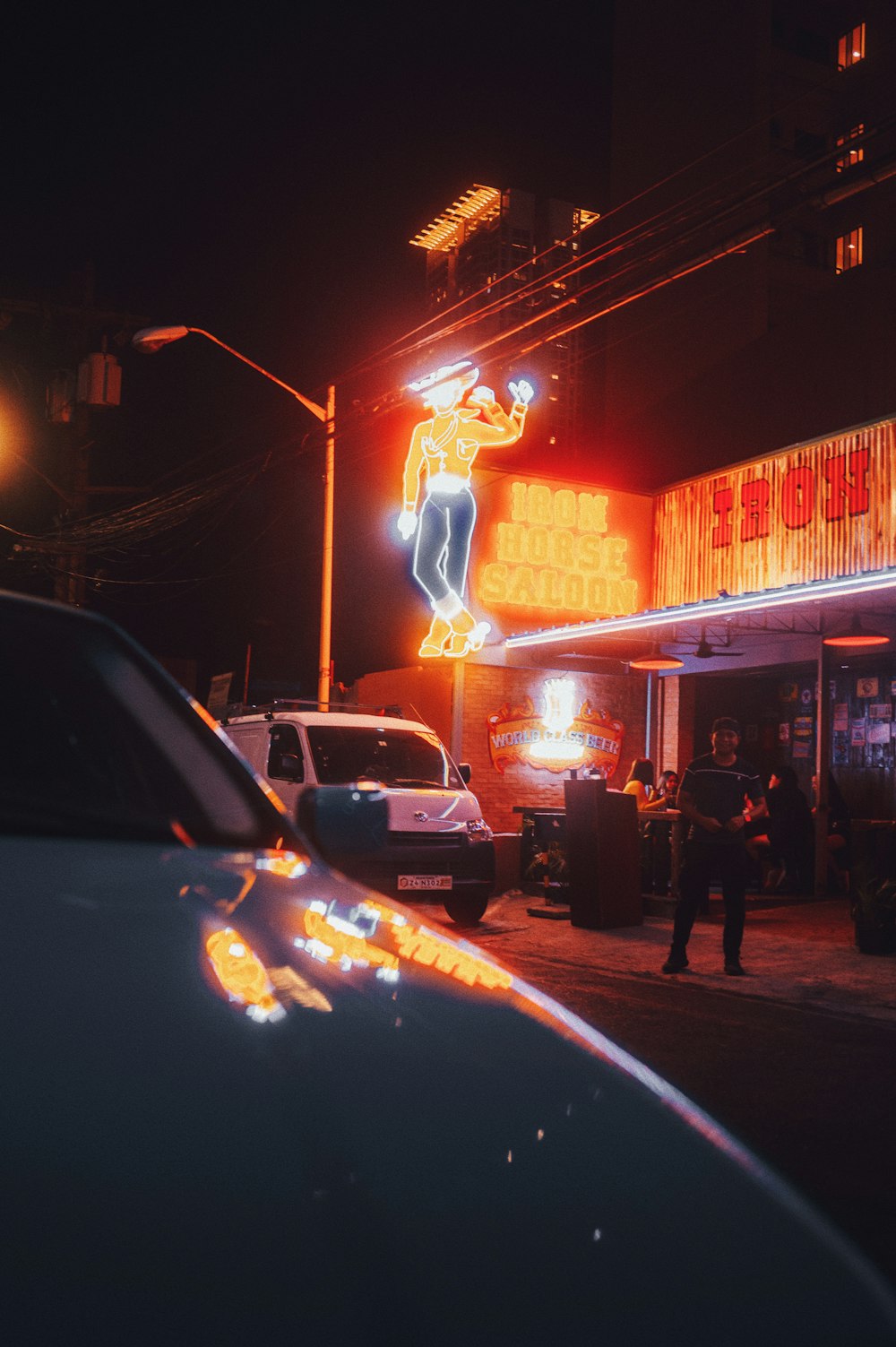 a police car parked in front of a neon sign