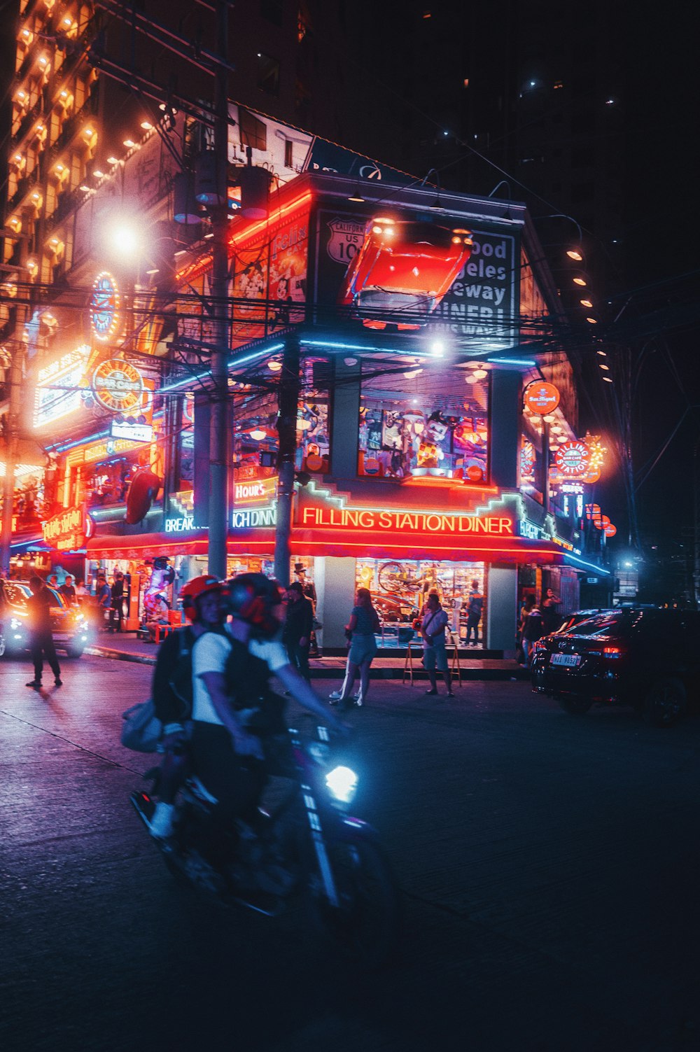 a man riding a motorcycle down a street at night