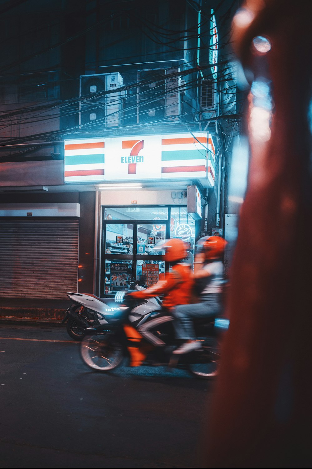 a man riding a motorcycle down a street at night