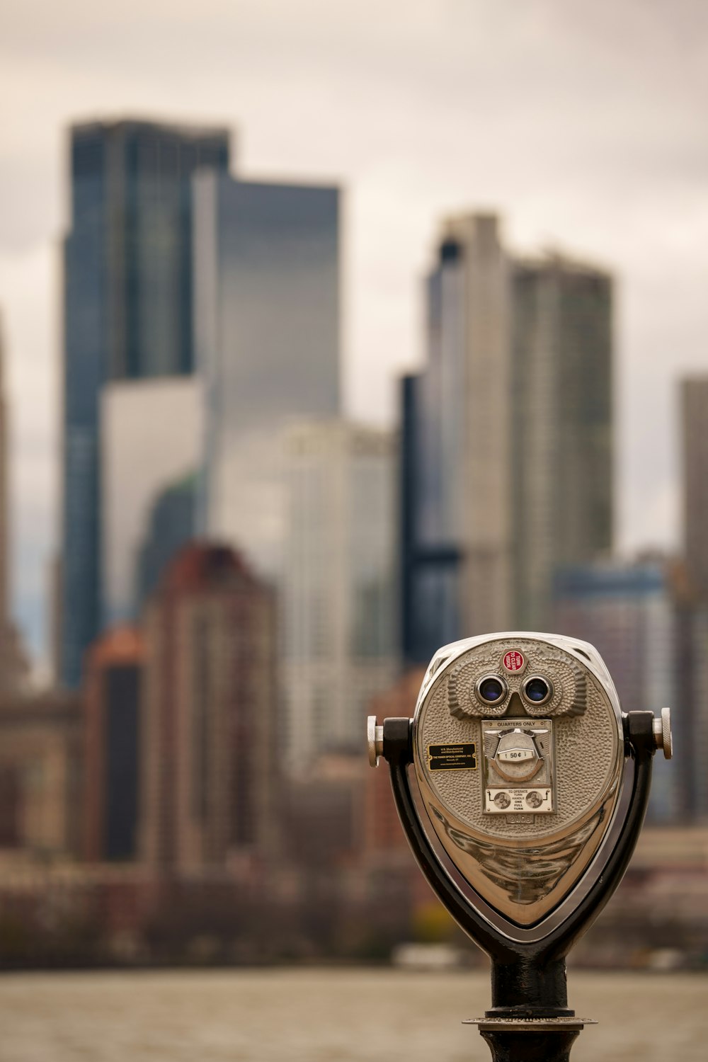 a coin operated parking meter in front of a city skyline