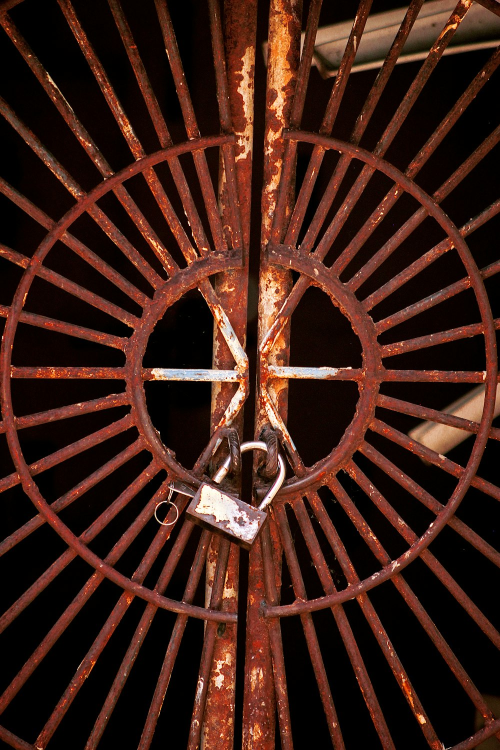 a close up of a metal gate with a lock on it
