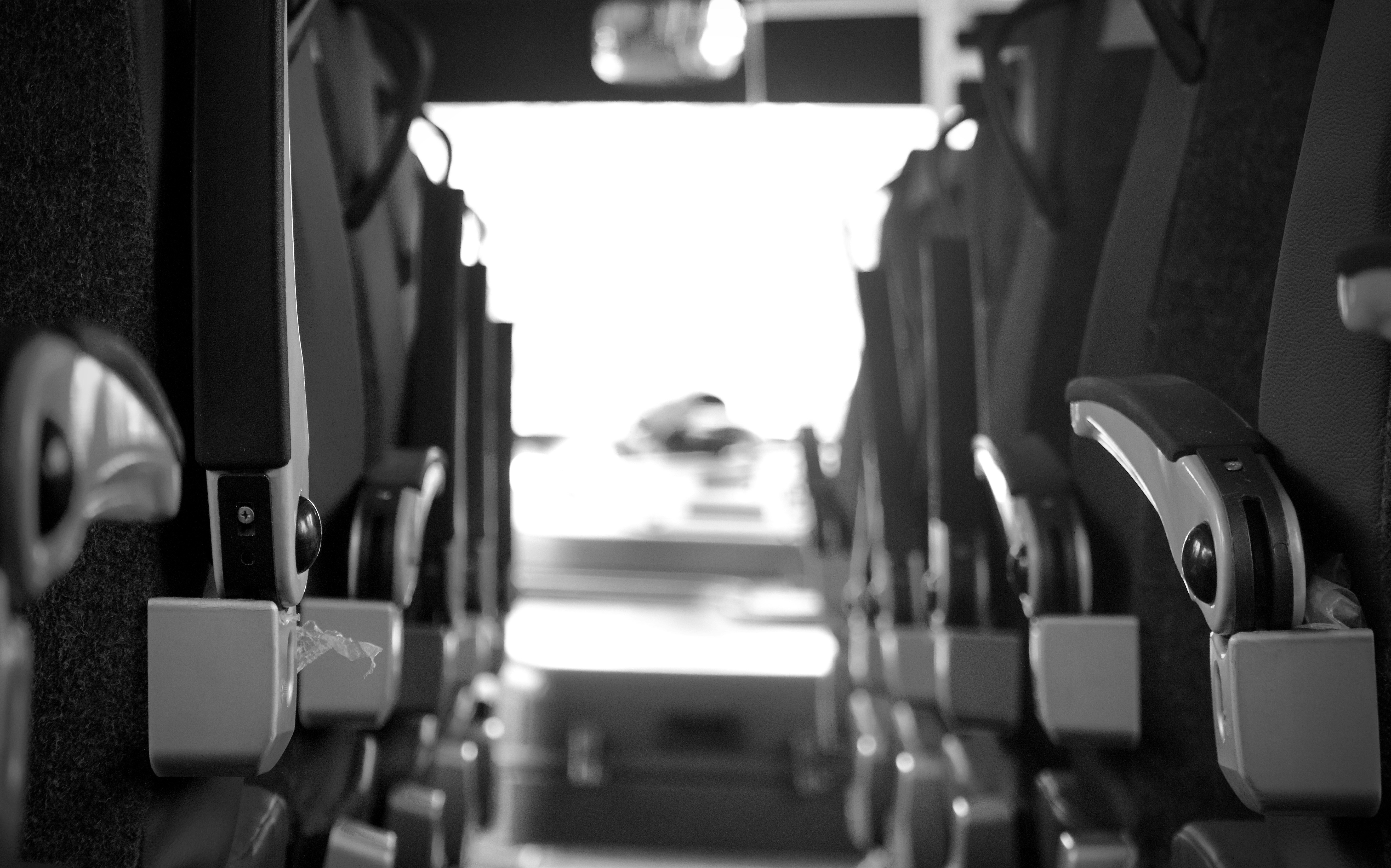 a black and white photo of seats in an airplane