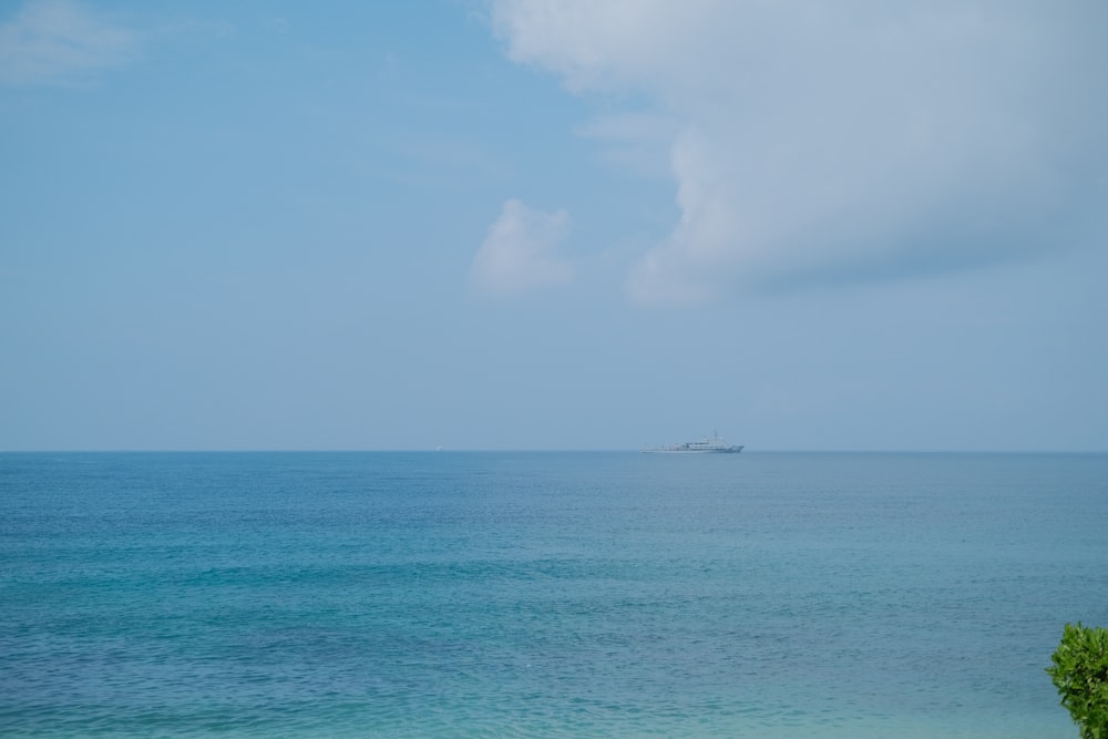 a large body of water with a boat in the distance