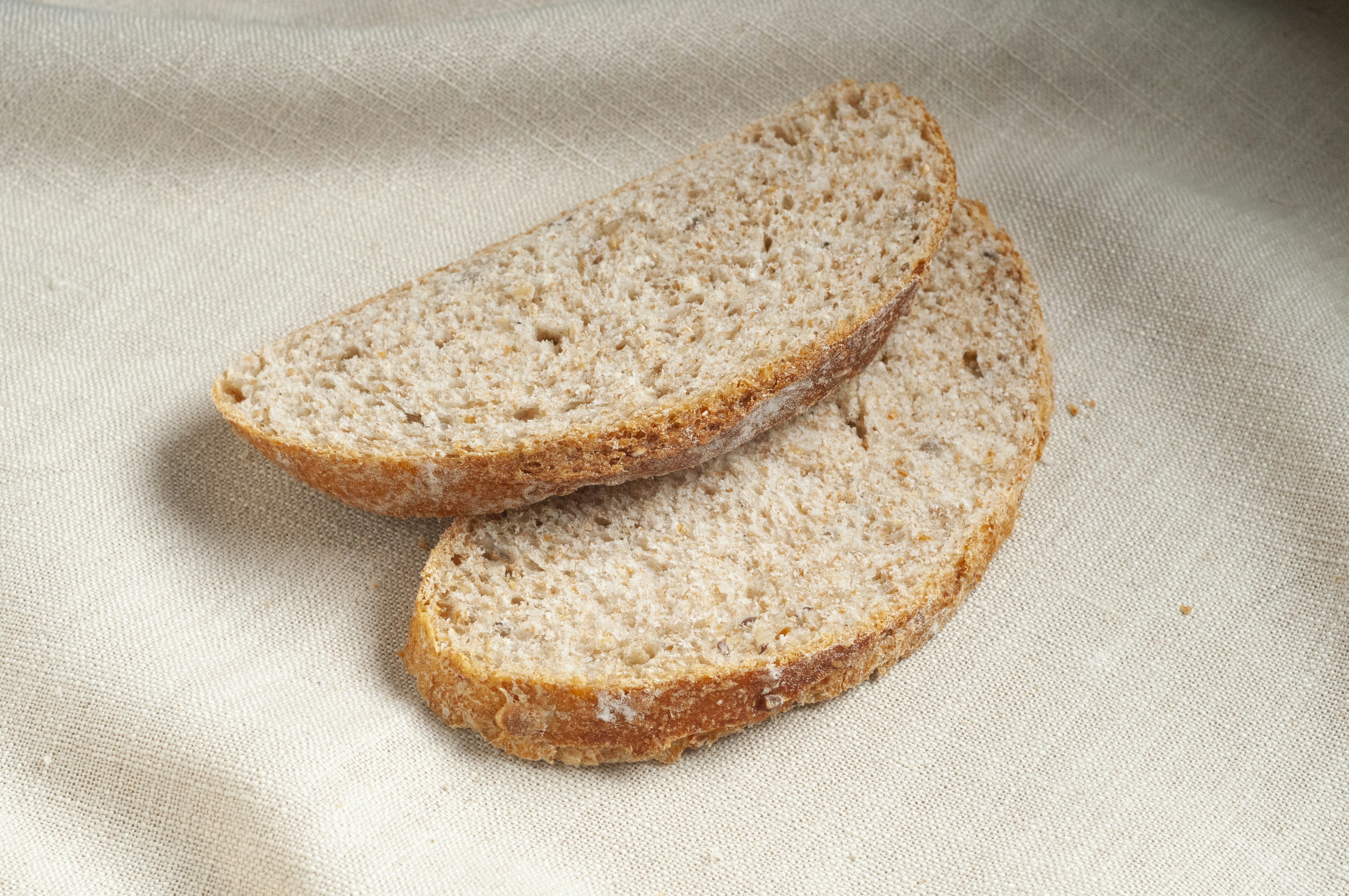 two slices of bread sitting on top of a white cloth