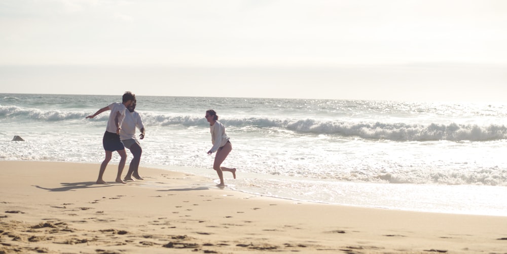 a couple of people that are standing in the sand