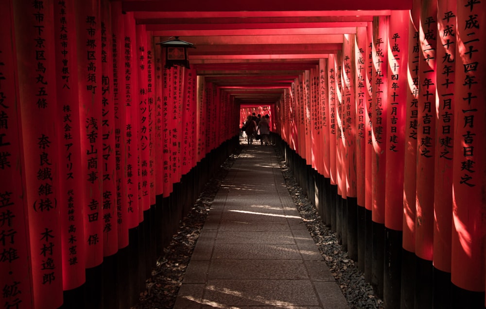 a walkway lined with red and black lanterns