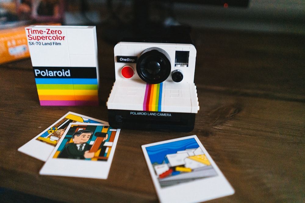 a polaroid camera sitting on top of a wooden table