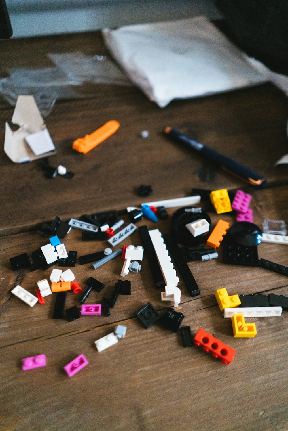 a pile of legos sitting on top of a wooden table