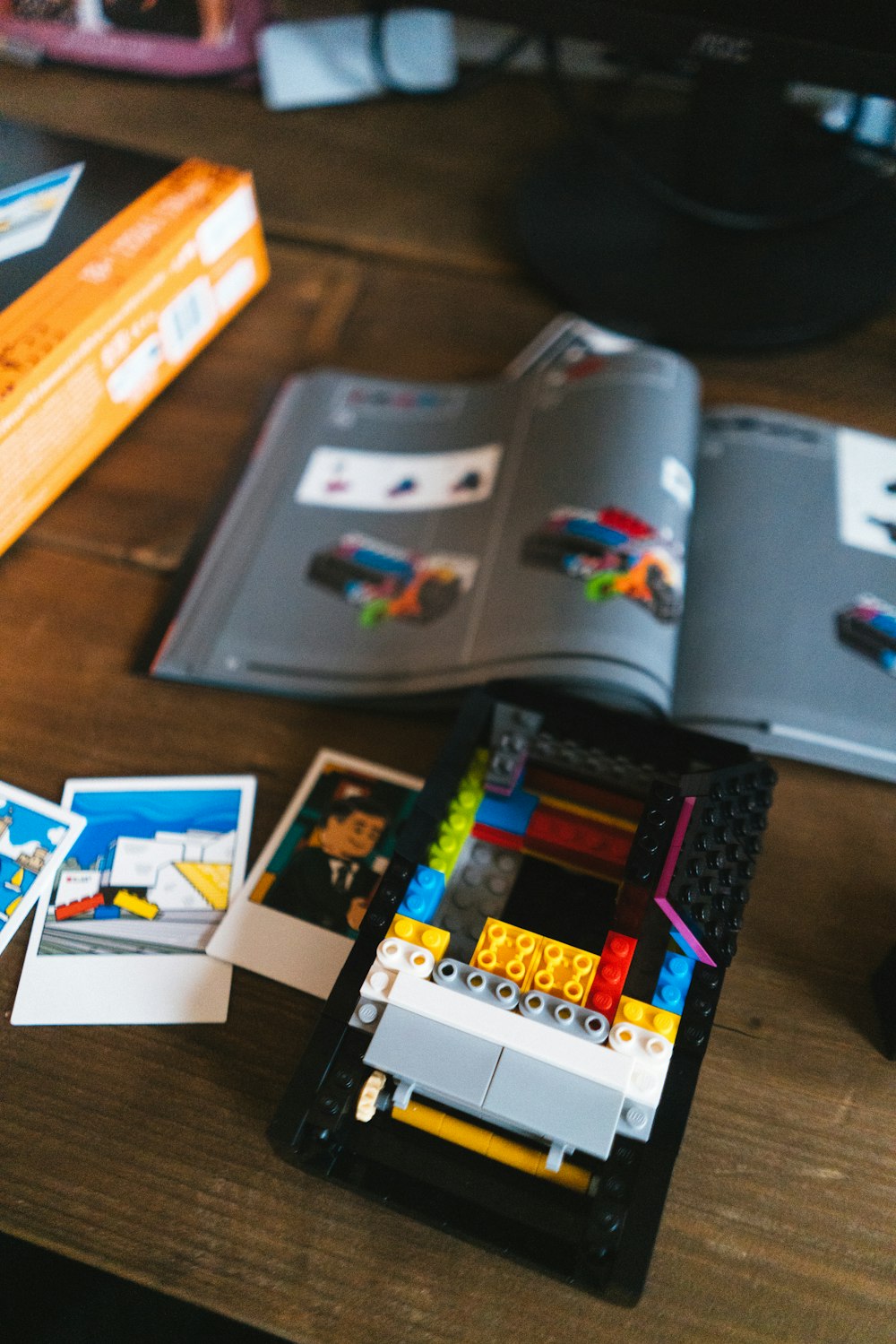 a table topped with legos and a book