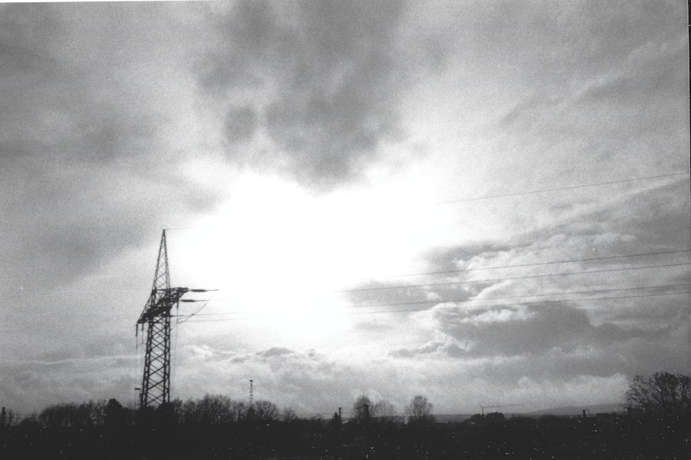 a black and white photo of a tower and power lines