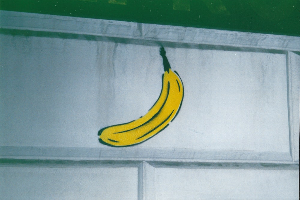 a picture of a banana hanging on a wall
