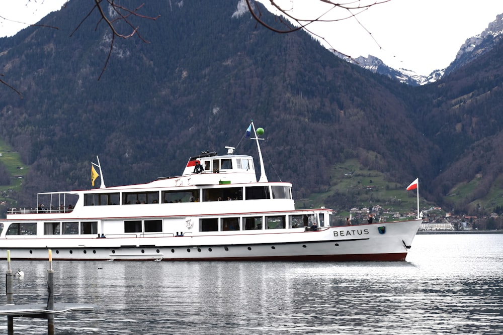 a large white boat floating on top of a lake