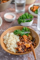 a bowl filled with rice, beans and vegetables