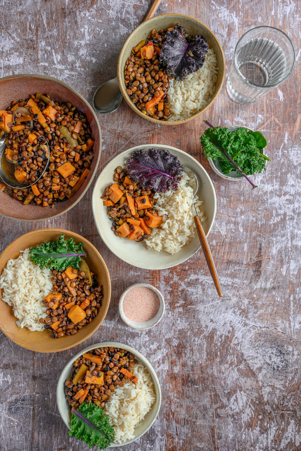 three bowls of food on a wooden table