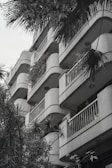 a black and white photo of a building with balconies