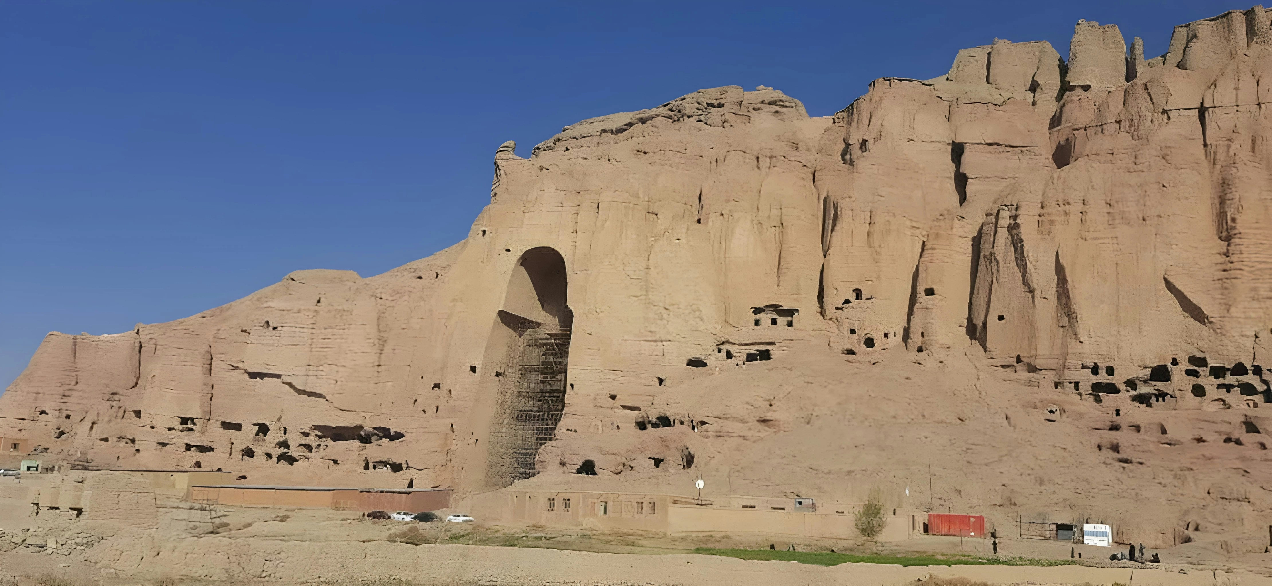 a large rock formation with a building in the middle of it