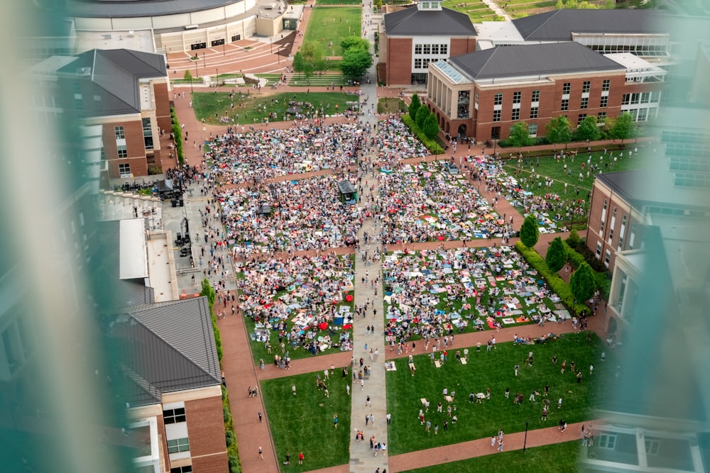 an aerial view of a large group of people gathered in a courtyard