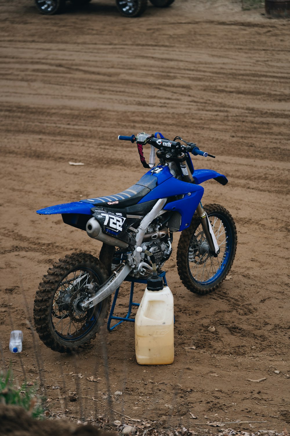 a dirt bike parked on top of a dirt field