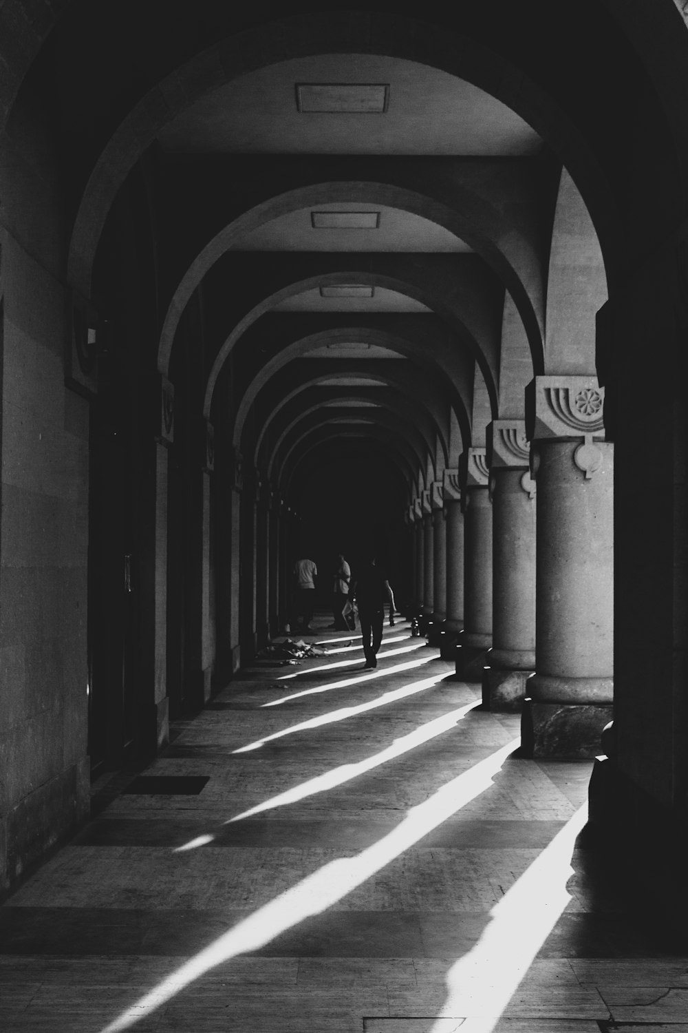 a black and white photo of a long hallway