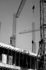 two men are working on a building under construction
