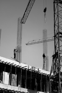 two men are working on a building under construction
