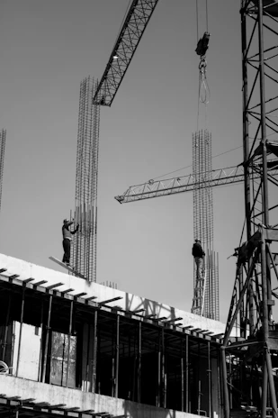 two men are working on a building under construction