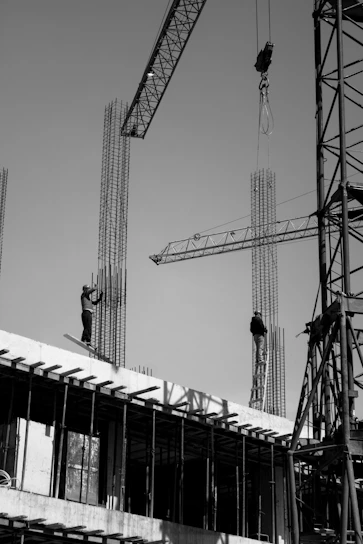 two men are working on a building under construction