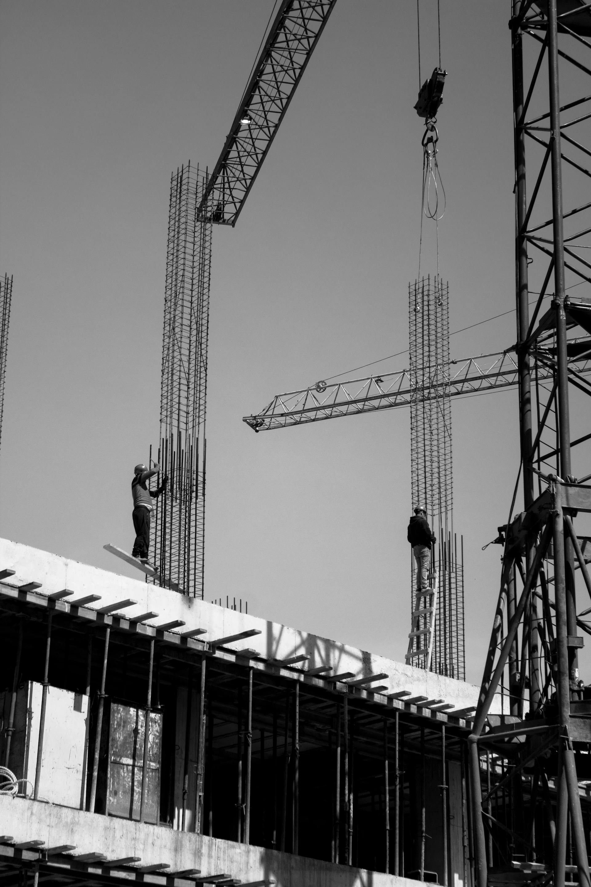 two men are working on a building under construction