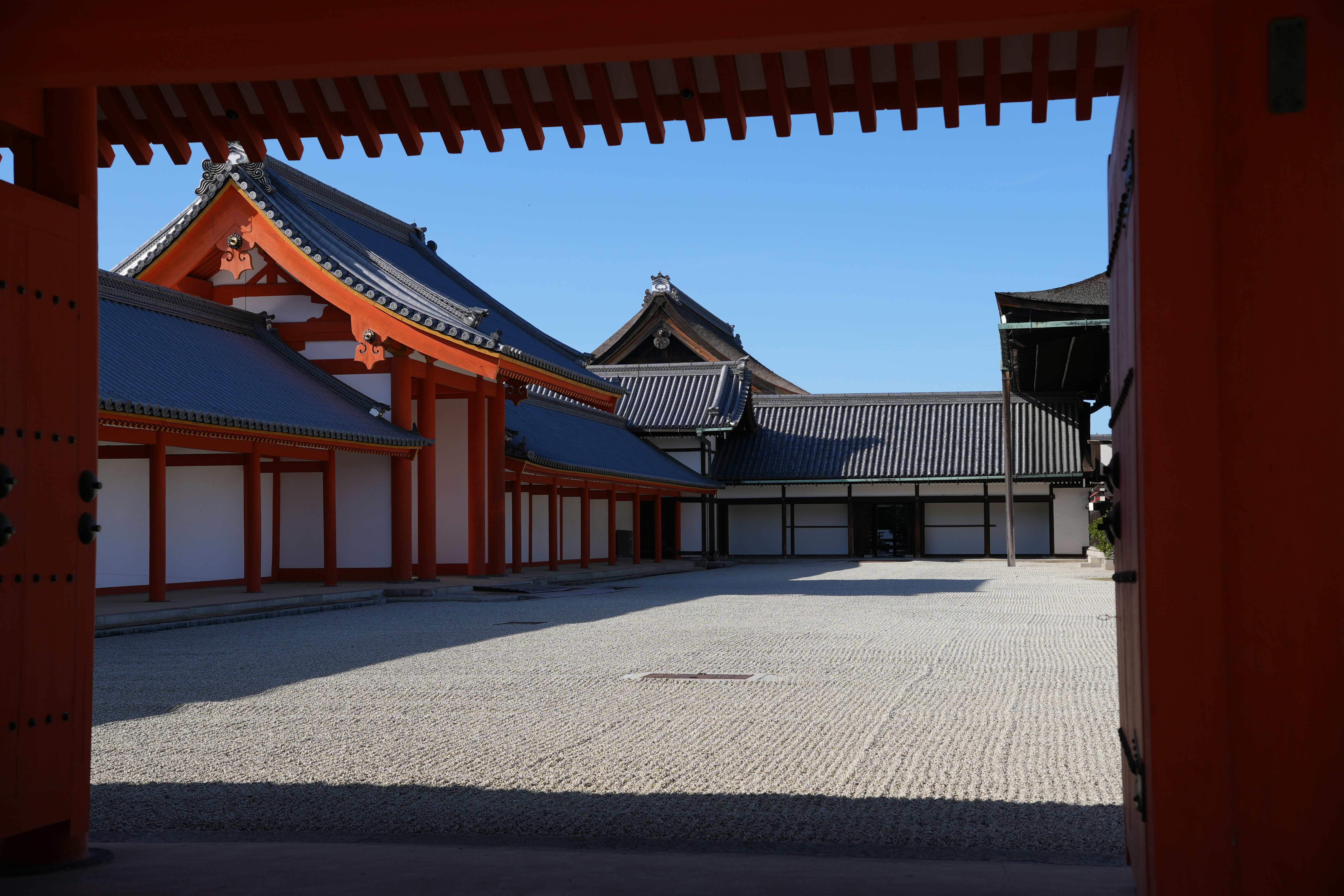 a large courtyard with a building in the background