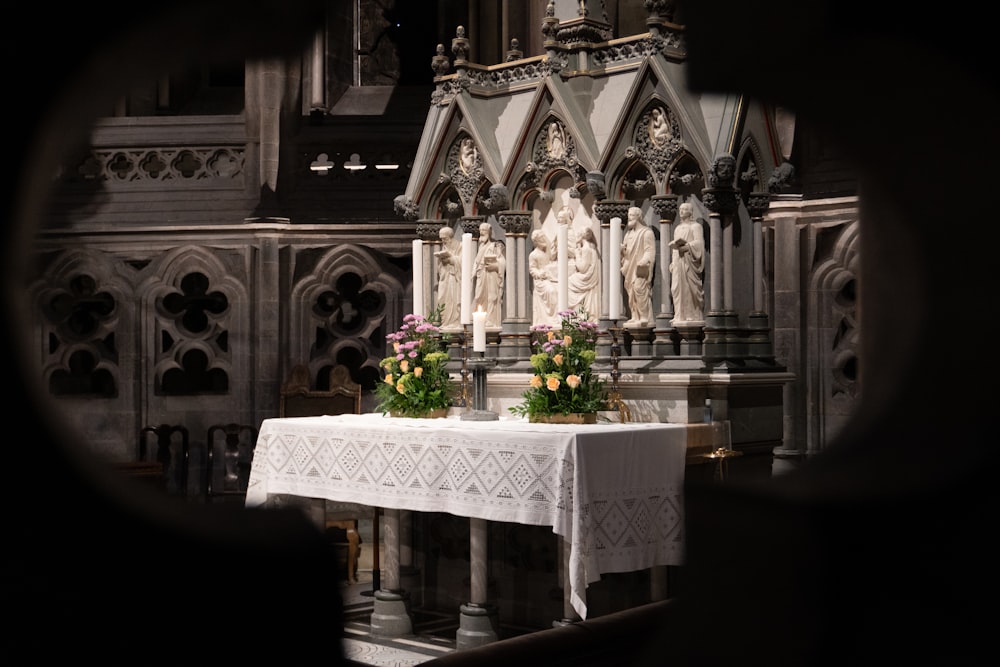 a table with flowers on it in front of a church