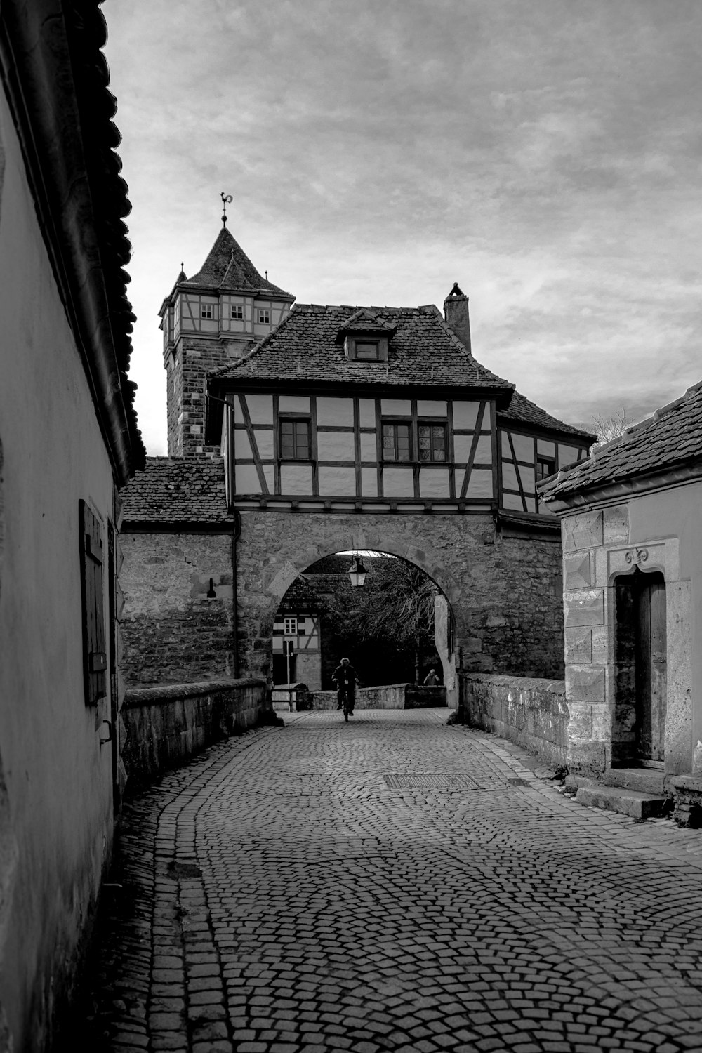 a black and white photo of a cobblestone street