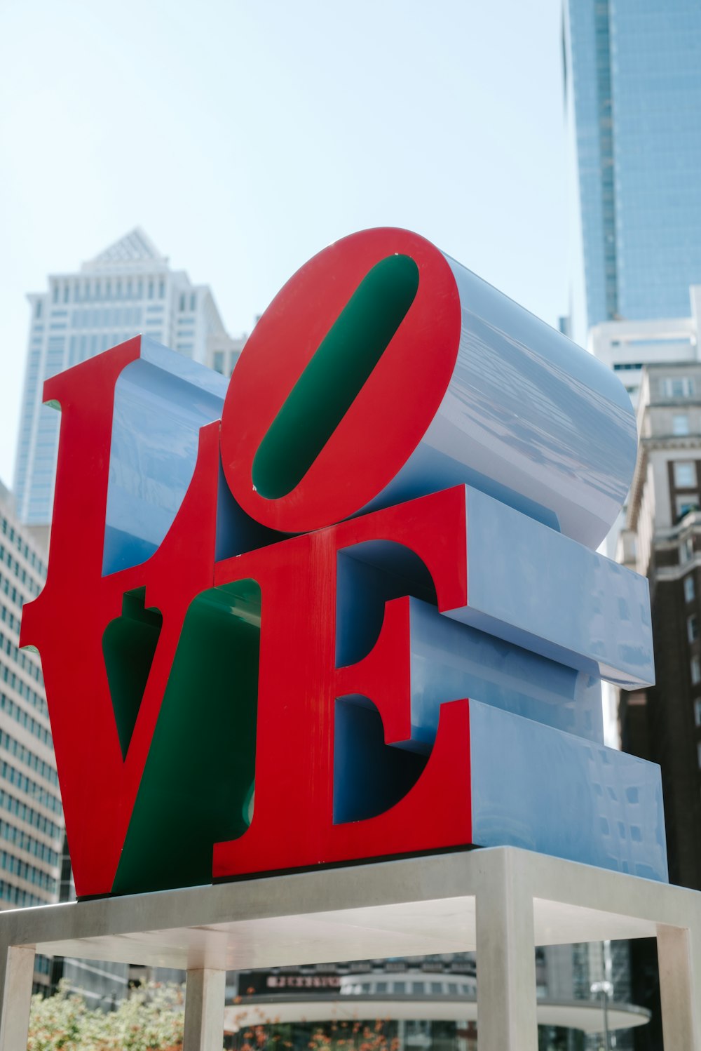 a large love sculpture in the middle of a city