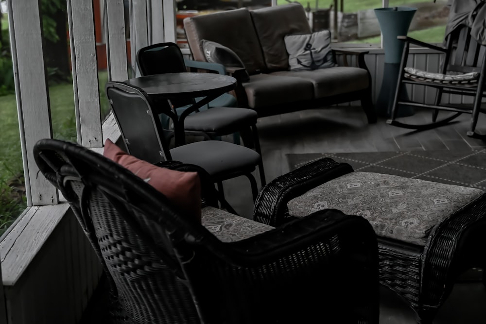 a porch with chairs and a table on it