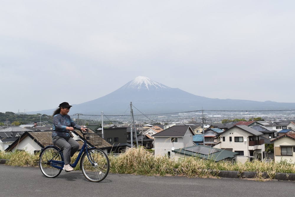 a woman riding a bike down a street