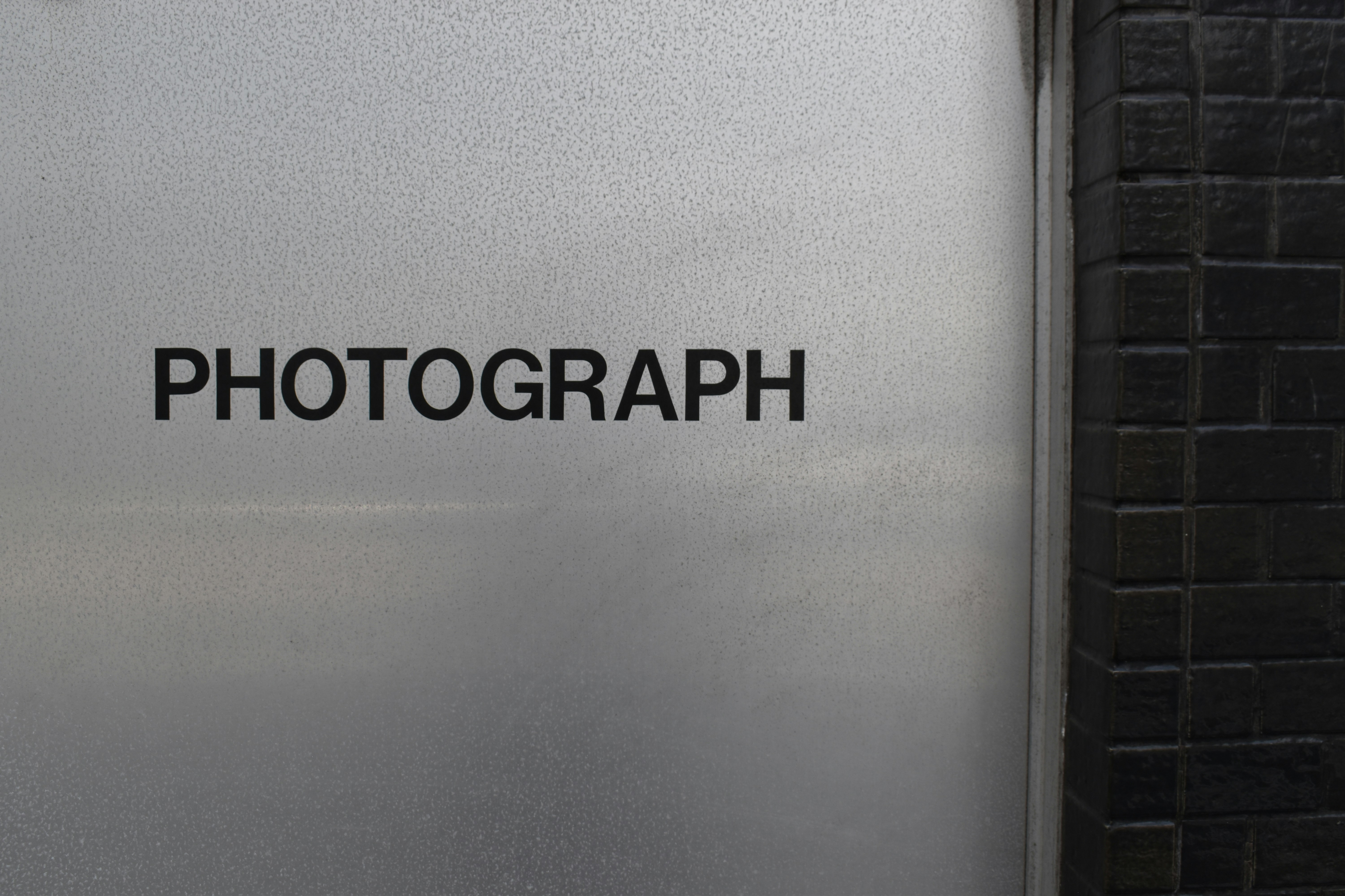 a close up of a metal door with the word photography on it