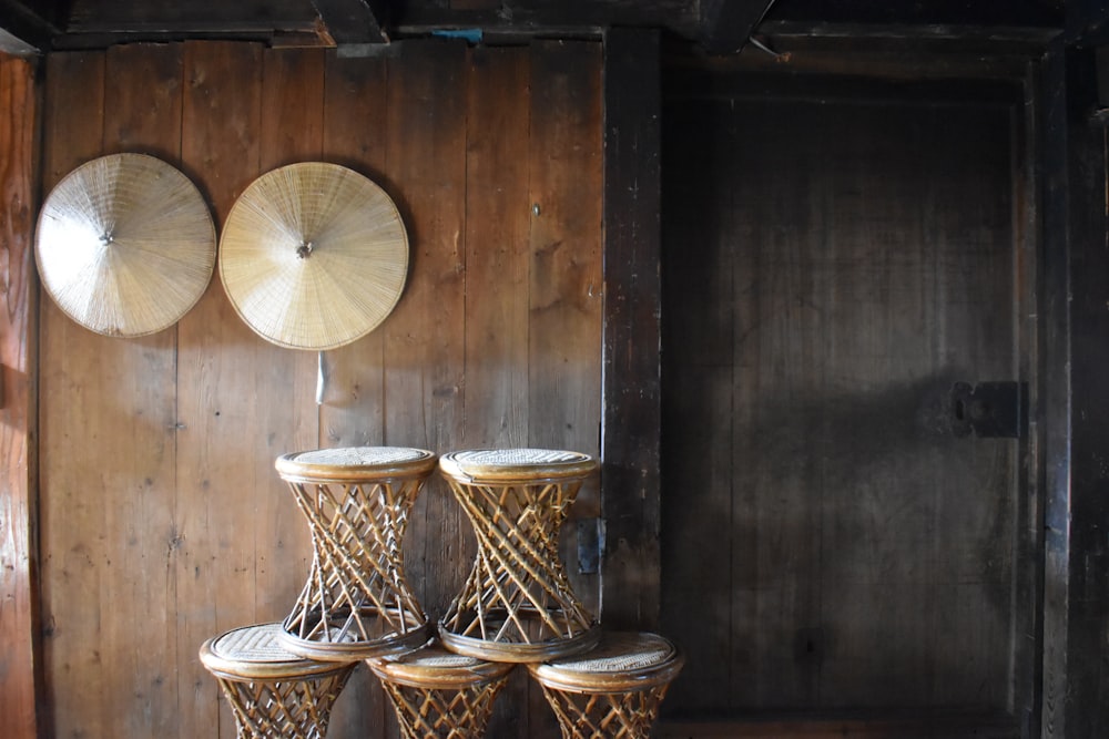 a group of stools sitting next to each other in front of a wooden wall