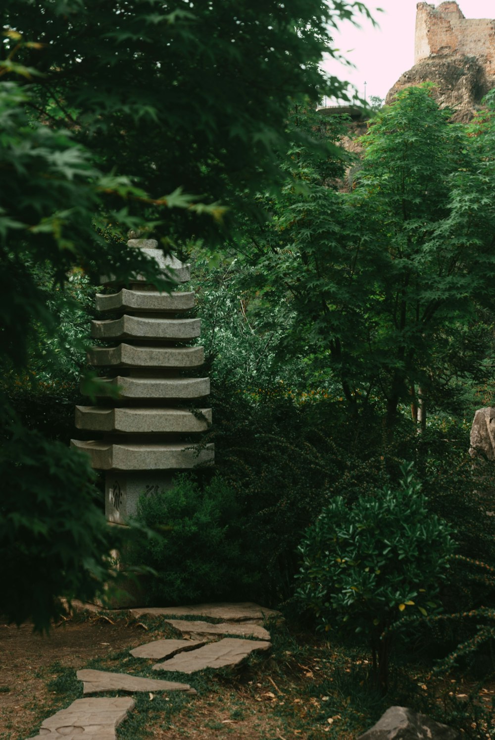 a stone path with steps leading up to a castle