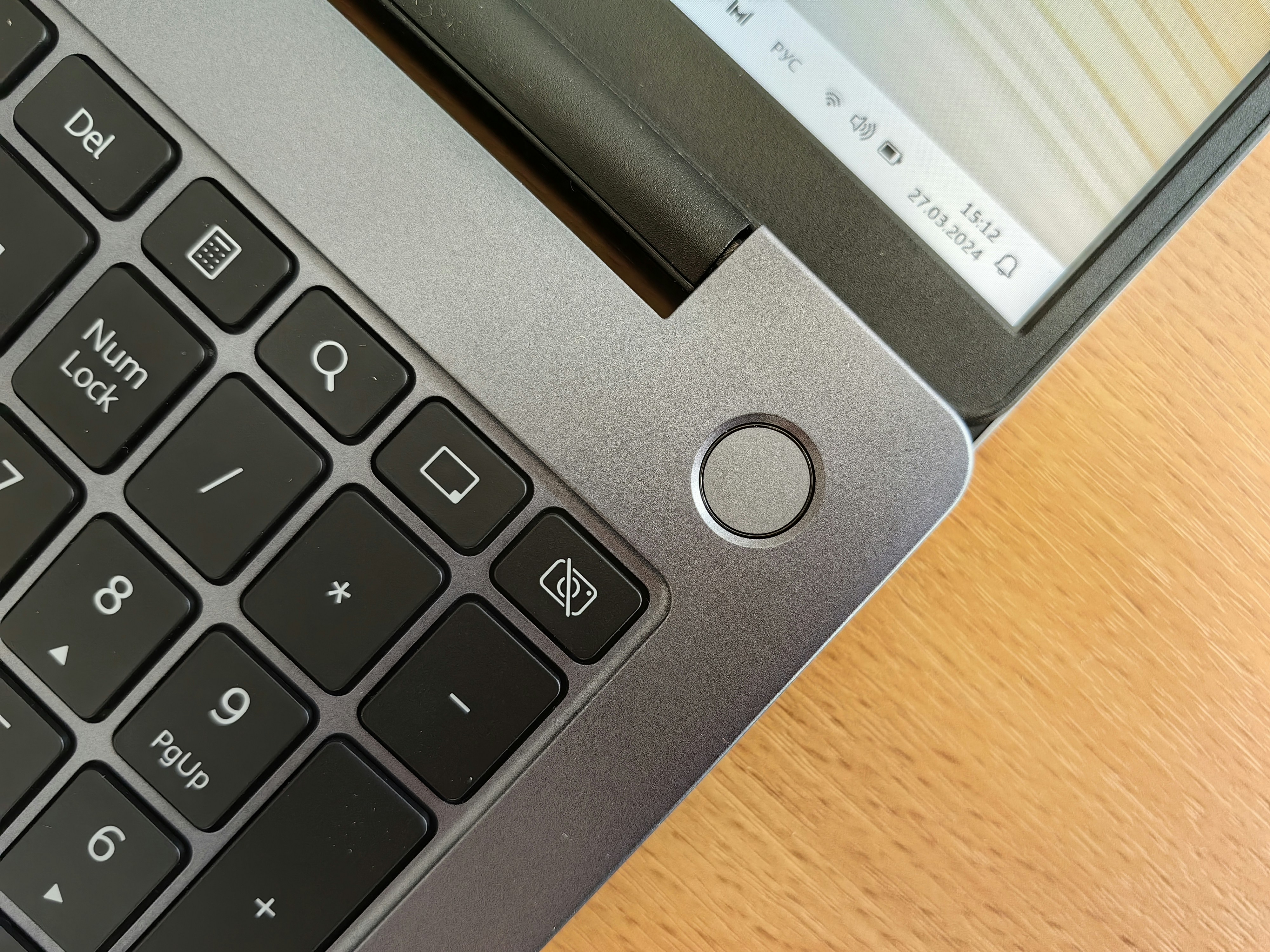 A person scanning their fingerprint on a time clock