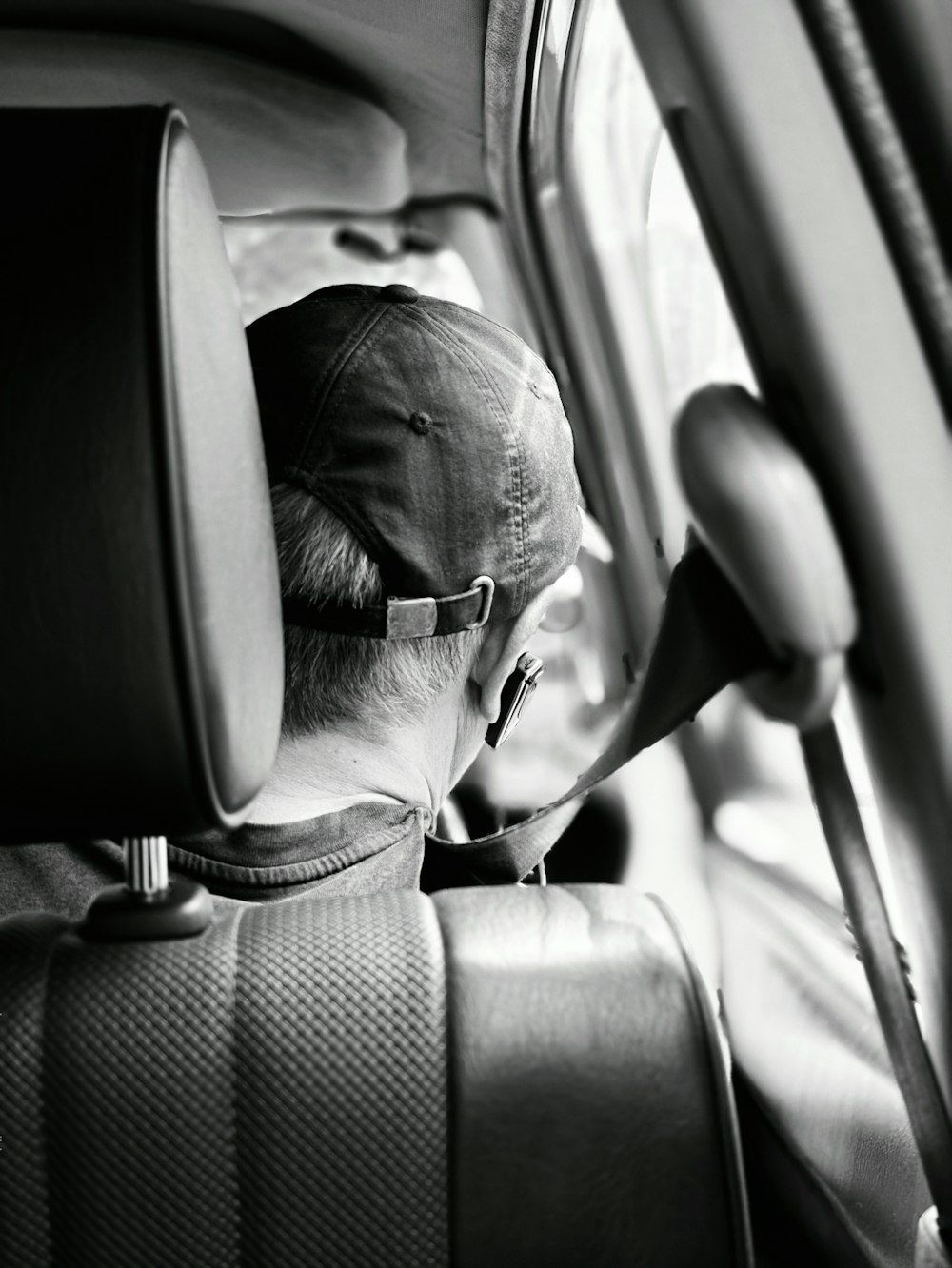 a man sitting in the back seat of a car