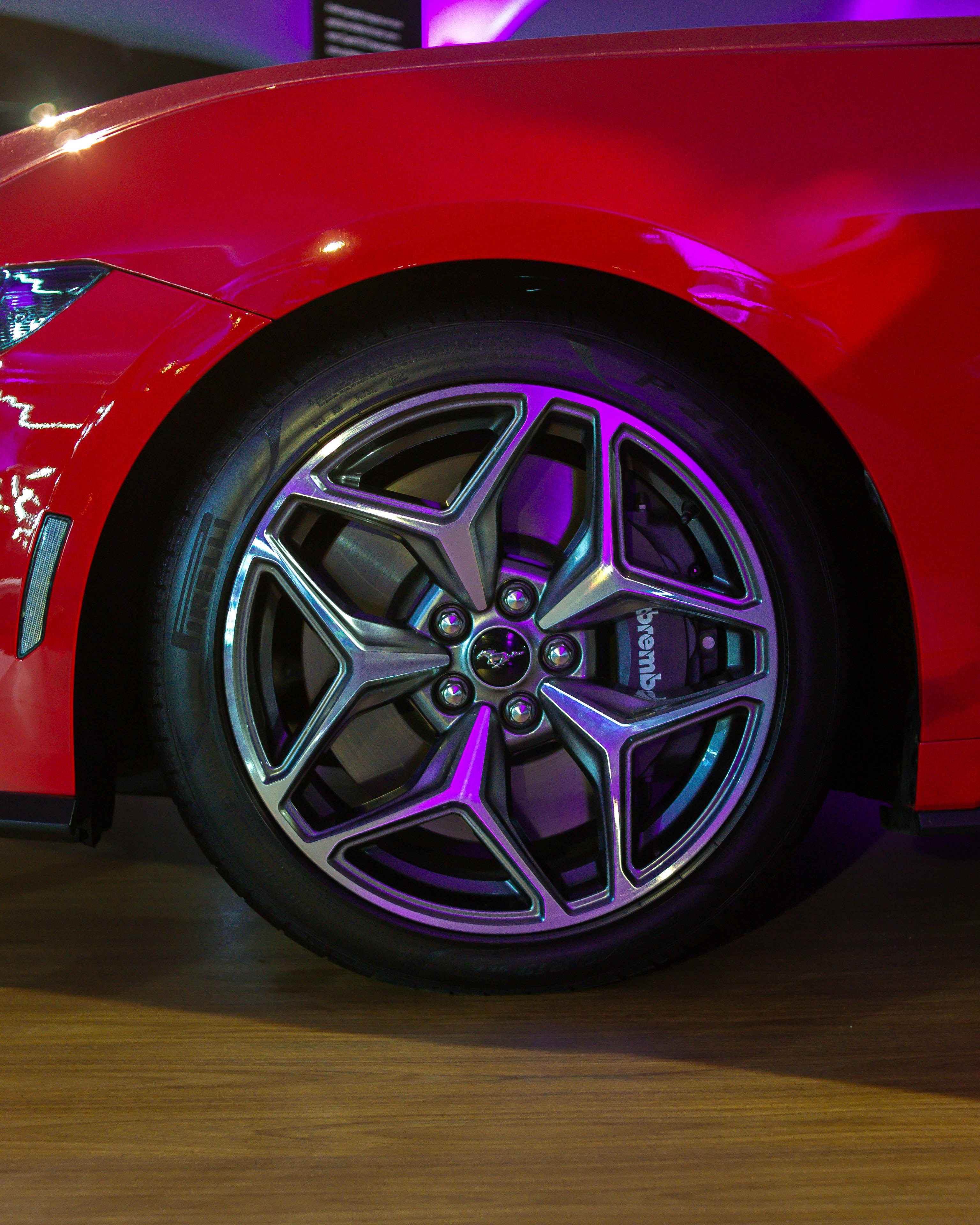 a close up of a car wheel on a wooden floor