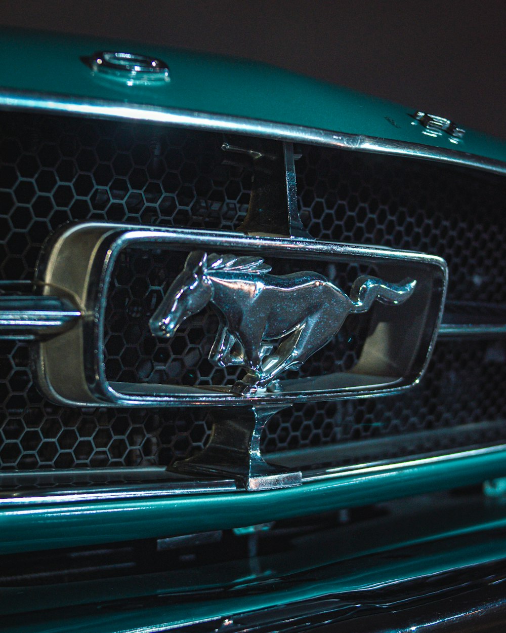 a close up of a horse emblem on the front of a car