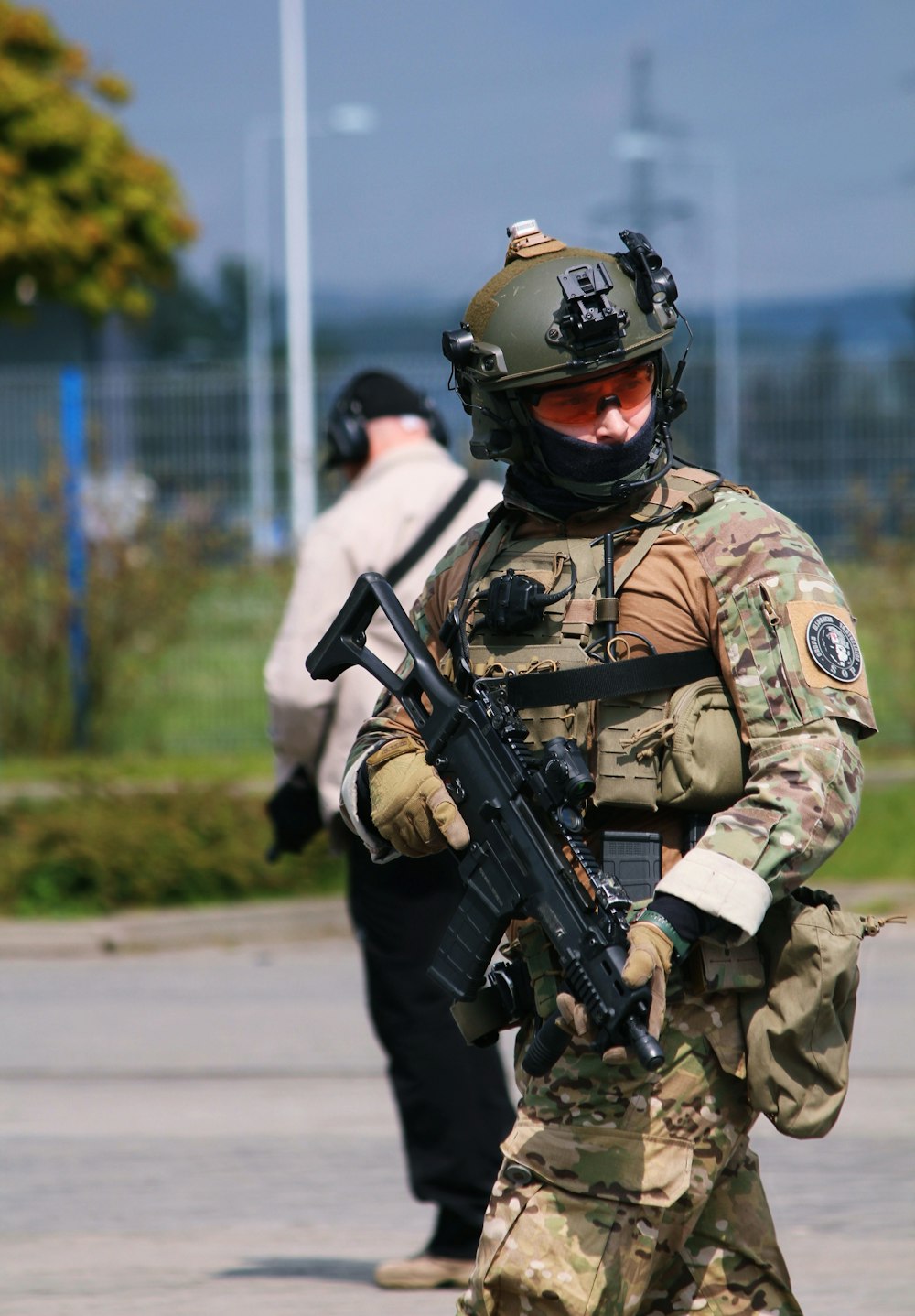 a man in camouflage holding a machine gun