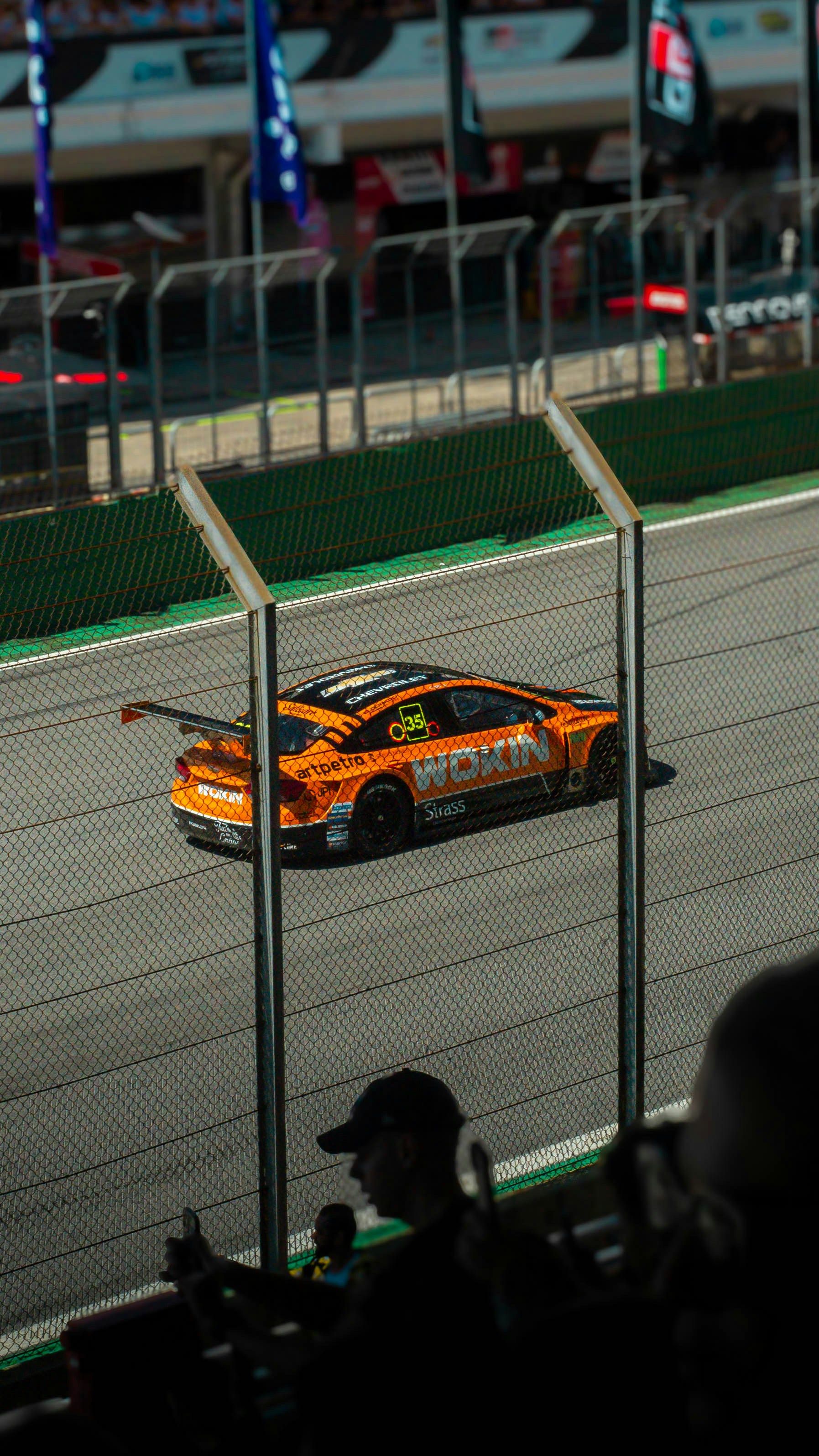 a car driving down a race track at night