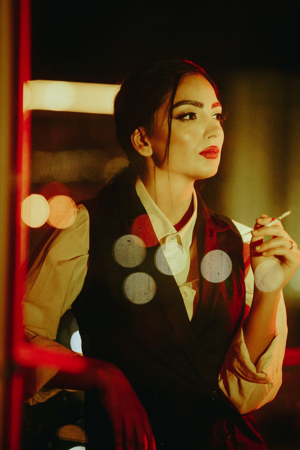 a woman smoking a cigarette in front of a mirror