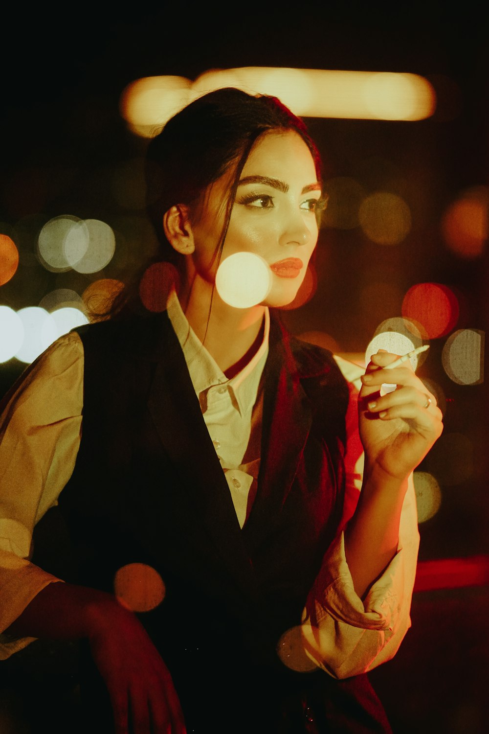 a woman smoking a cigarette in the dark