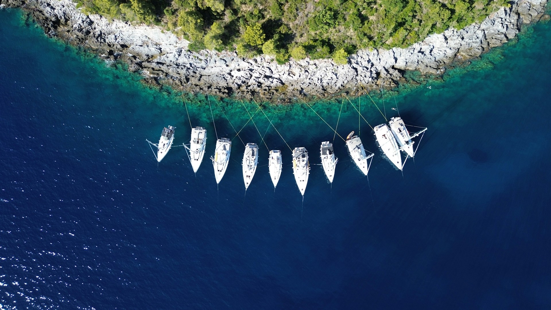 a group of boats floating on top of a body of water
