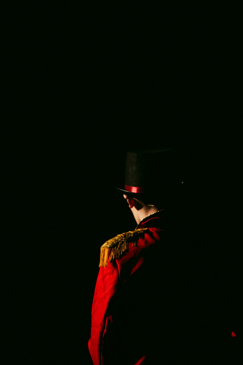 a man in a red coat and top hat