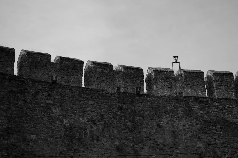 a black and white photo of a castle wall