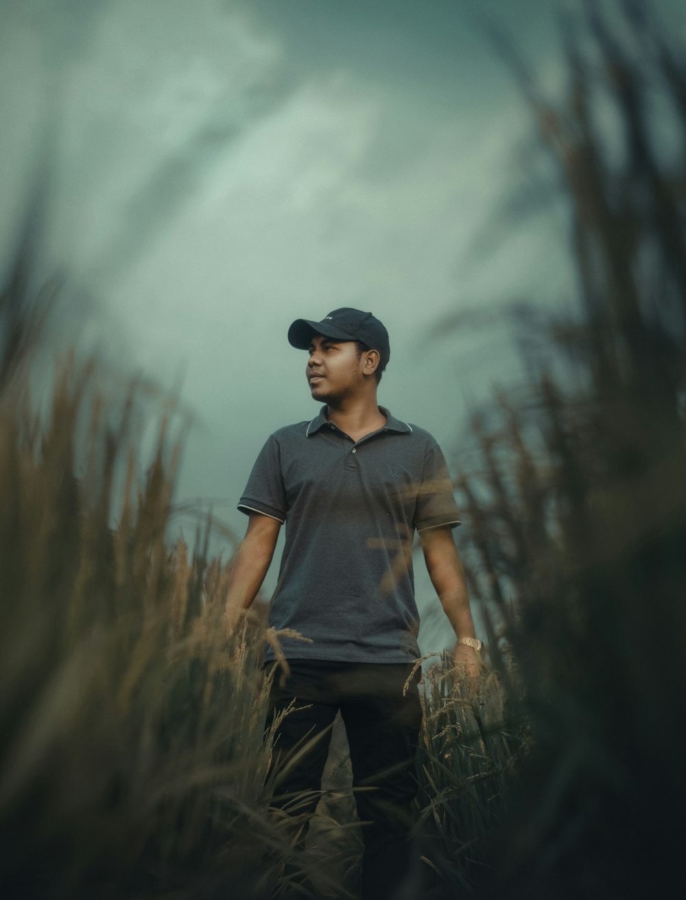 a man standing in a field of tall grass